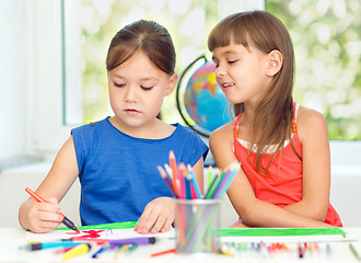 Image showing Little girls are drawing using pencils