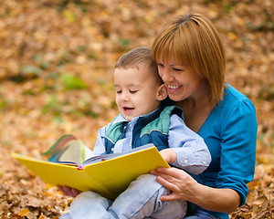 Image showing Mother is reading book with her son