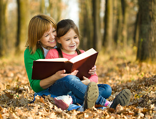 Image showing Mother is reading book with her daughter