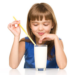 Image showing Cute little girl with a glass of milk