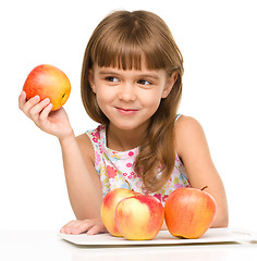 Image showing Little girl with red apples