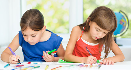 Image showing Little girls are drawing using pencils