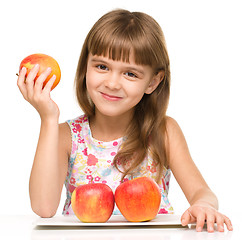 Image showing Little girl with red apples