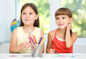 Image showing Little girls are drawing using pencils