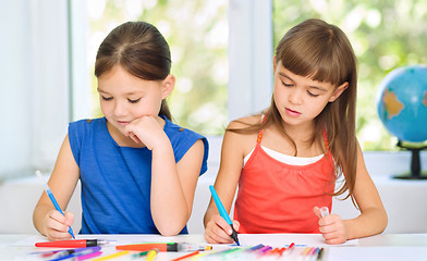 Image showing Little girls are drawing using pencils