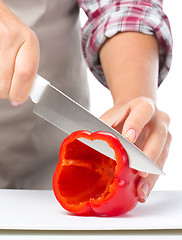 Image showing Cook is chopping bell pepper