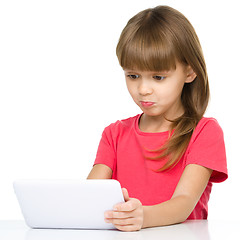 Image showing Young girl is using tablet