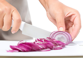 Image showing Cook is chopping onion