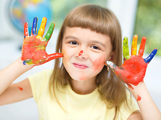 Image showing Portrait of a cute girl playing with paints