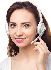 Image showing Lovely young woman is talking to customers