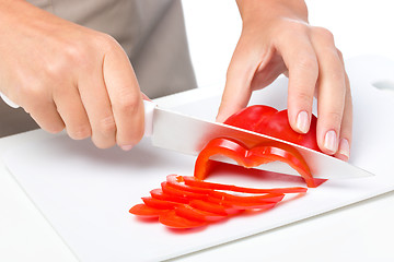 Image showing Cook is chopping bell pepper