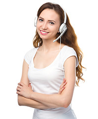 Image showing Lovely young woman is talking to customers