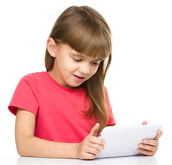 Image showing Young girl is using tablet