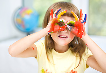 Image showing Portrait of a cute girl playing with paints