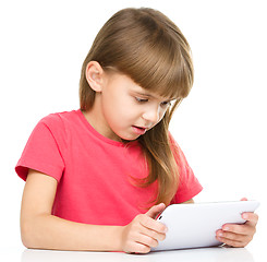 Image showing Young girl is using tablet while studying