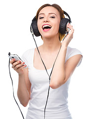 Image showing Young woman enjoying music using headphones