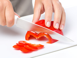 Image showing Cook is chopping bell pepper