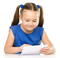 Image showing Young girl is using tablet