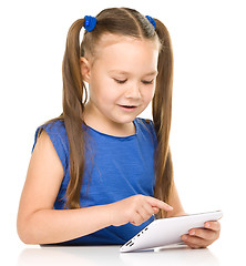 Image showing Young girl is using tablet