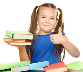 Image showing Little girl is reading a book