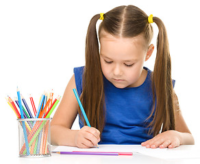 Image showing Little girl is painting with gouache