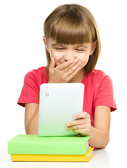 Image showing Young girl is using tablet while studying