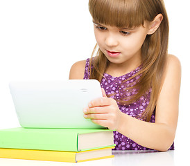 Image showing Young girl is using tablet