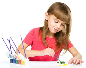 Image showing Little girl is painting with gouache