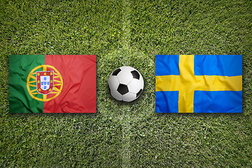 Image showing Portugal vs. Sweden flags on soccer field