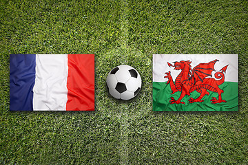 Image showing France vs. Wales flags on soccer field