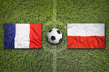 Image showing France vs. Poland flags on soccer field