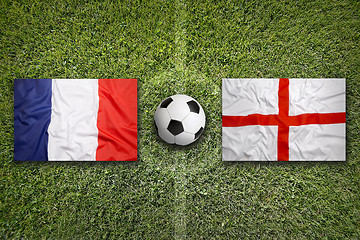 Image showing France vs. England flags on soccer field