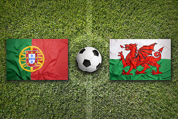 Image showing Portugal vs. Wales flags on soccer field