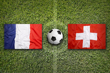 Image showing France vs. Switzerland flags on soccer field