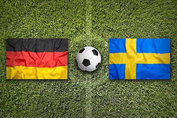 Image showing Germany vs. Sweden flags on soccer field
