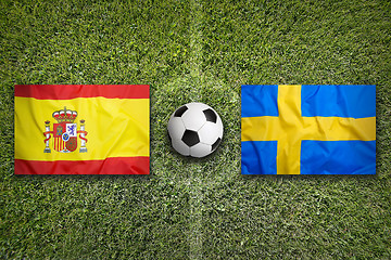 Image showing Spain vs. Sweden flags on soccer field