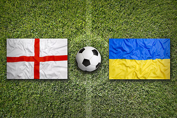 Image showing England vs. Ukraine flags on soccer field