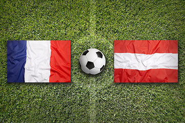 Image showing France vs. Austria flags on soccer field