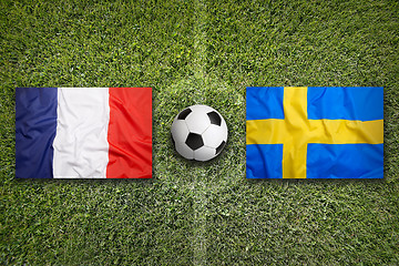 Image showing France vs. Sweden flags on soccer field