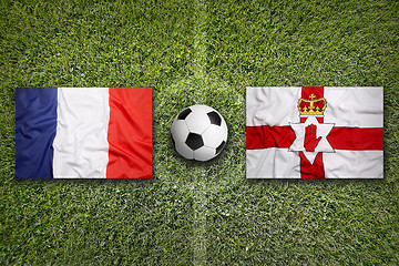 Image showing France vs. Northern Ireland flags on soccer field