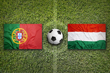 Image showing Portugal vs. Hungary flags on soccer field