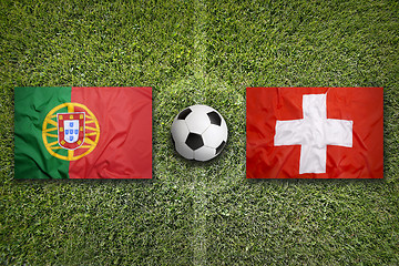 Image showing Portugal vs. Switzerland flags on soccer field