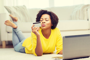 Image showing happy african woman with laptop and credit card