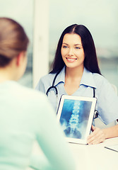 Image showing doctor or nurse showing x-ray with tablet pc