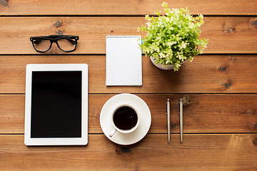 Image showing close up of tablet pc, coffee, glasses and notepad