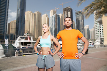 Image showing couple exercising over dubai city background