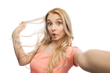 Image showing young woman taking selfie and making fish face