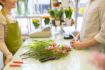 Image showing close up of florist woman and man at flower shop