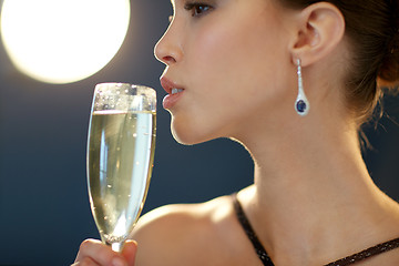 Image showing close up of woman drinking champagne at party