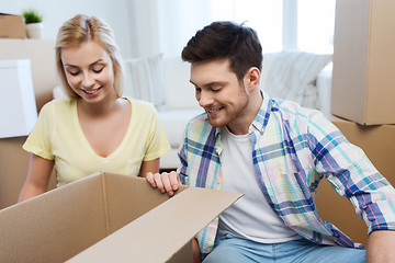 Image showing smiling couple with big boxes moving to new home